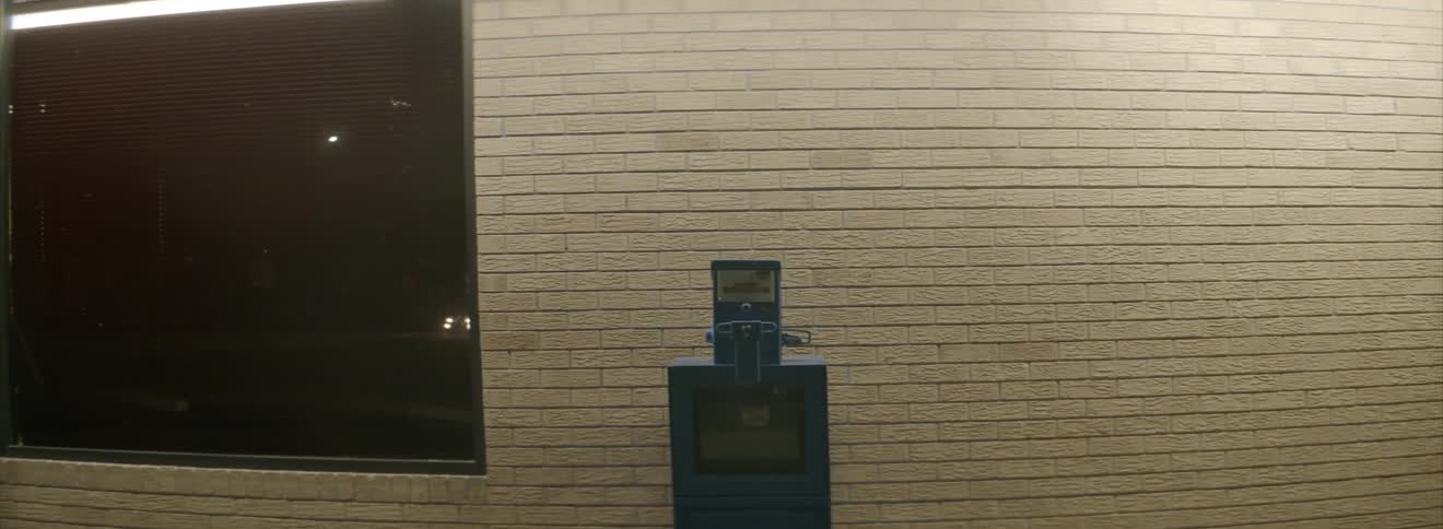 A newspaper vending machine in front of a building