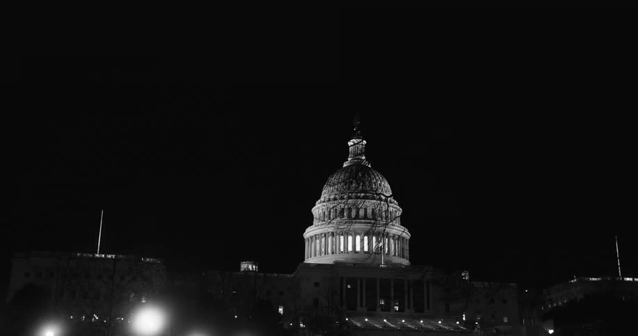 The dome to a government building is lit up at night
