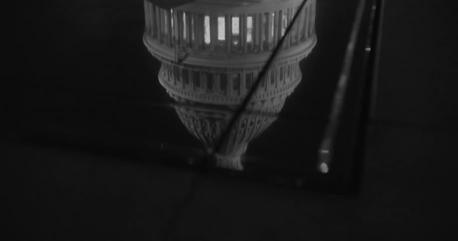 The capital building can be seen in the reflection