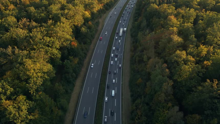 A group of vehicles driving down a highway