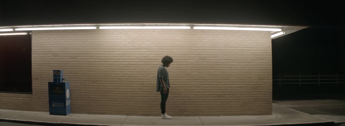 A woman stands on a concrete sidewalk