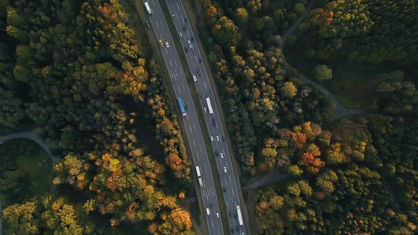 Aerial view of cars and trucks driving on a highway in the morning