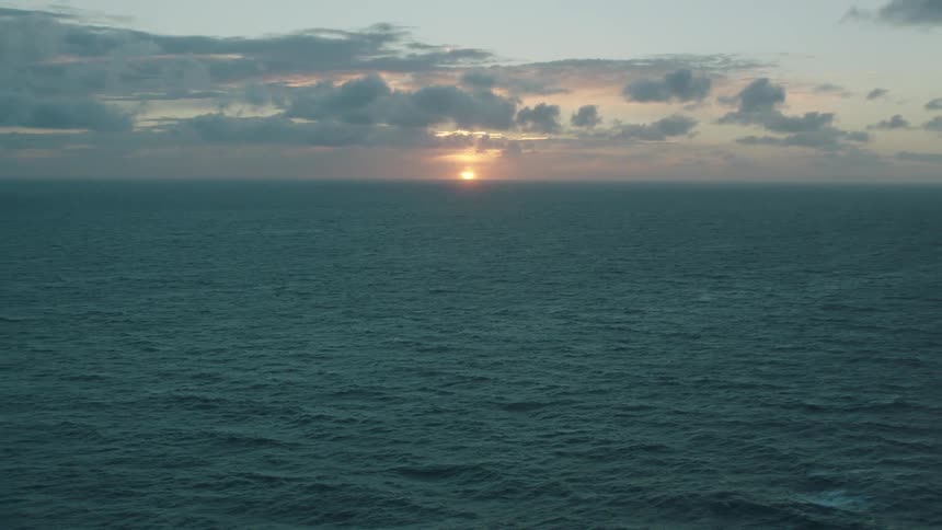 The sun on the horizon over the ocean at sunset