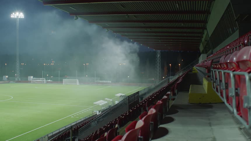 Smoke is on the field near the bleachers