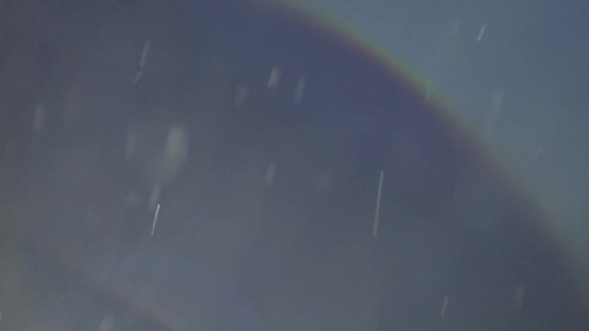 Rainbow curves across sky during storm