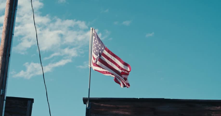 An american flag is waving in the wind