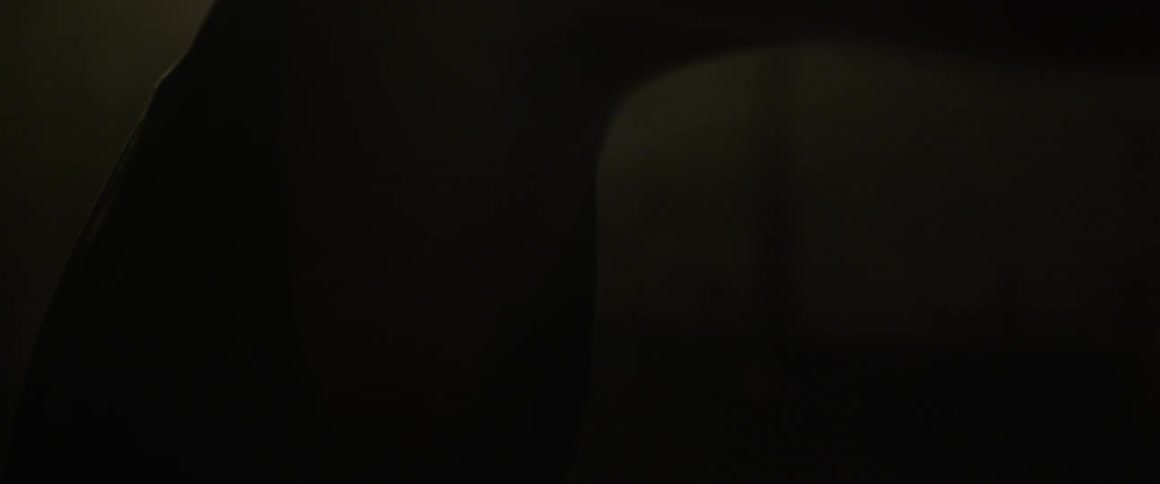 A person is boxing in a dark area