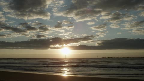 Waves come to shore at sunset