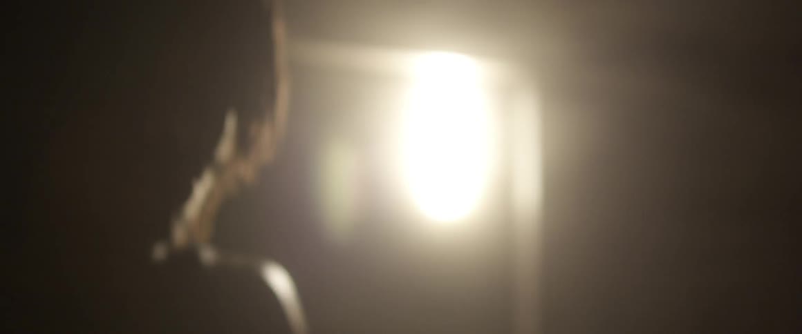 Close up of a person boxing in a dark area