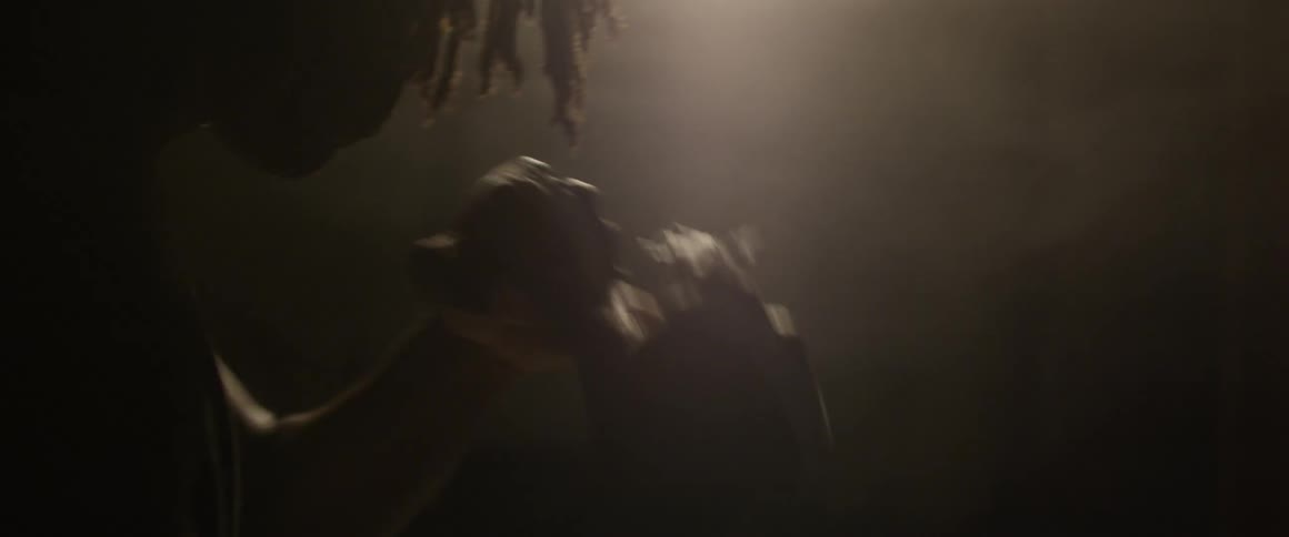 A person boxes in a dark areal