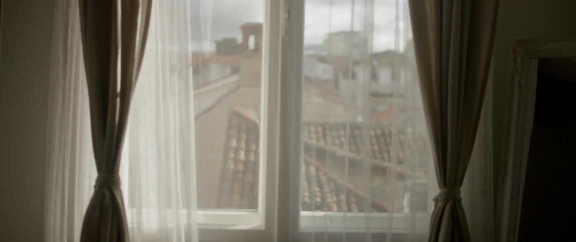 A drape is in front of a closed window