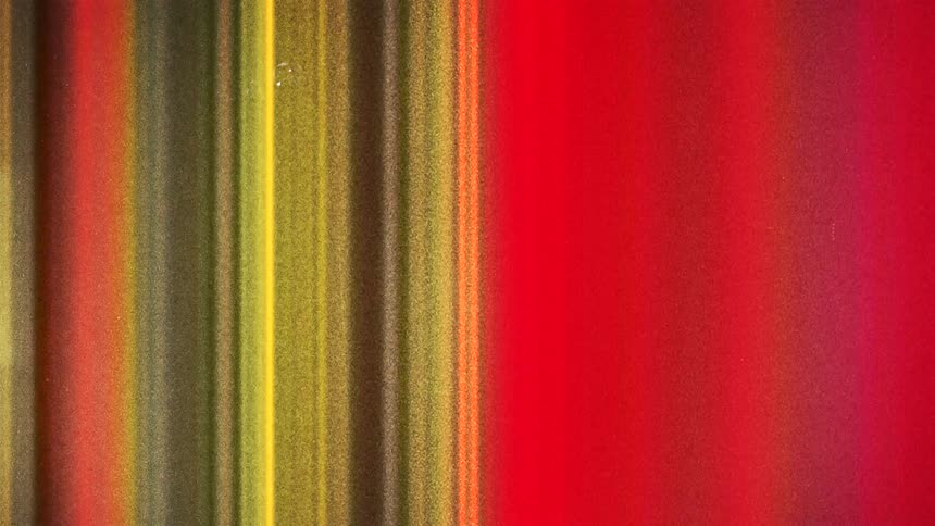 Vertical colorful red green lines moving chaotically caught on vintage film