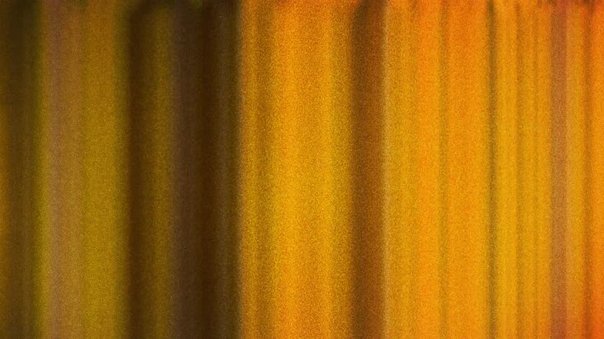 Moving vertical orange and yellow lines caught on vintage film