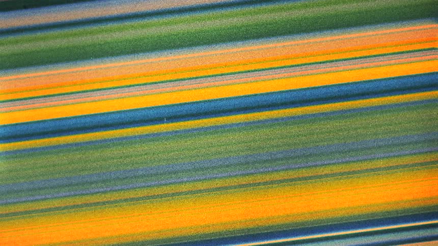 Colorful blue diagonal yellow moving green lines caught on vintage film