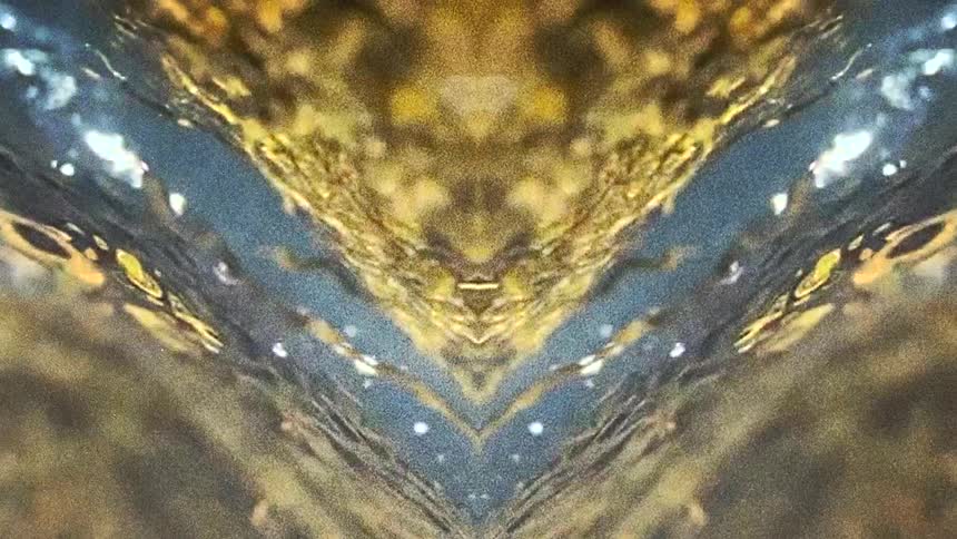 Gold and blue layers form triangles and glitter on digital graphic