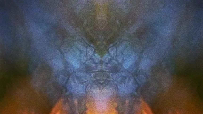 Reflected mirrored image of water flowing under random light flares caught on vintage film