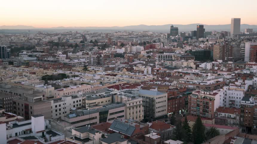 Night fades and the sun rises over a metropolis