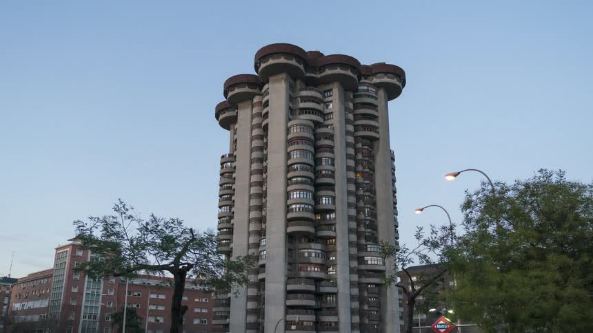 Tall modern building seen moving from night to day