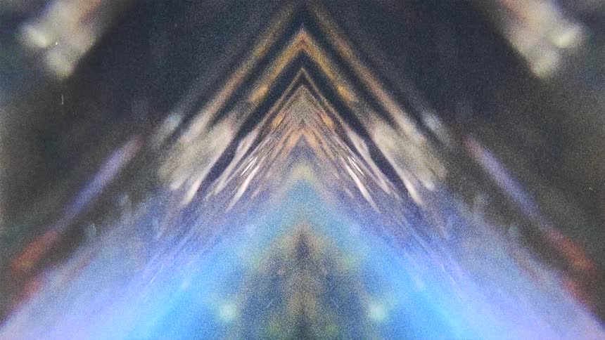 Mirror reflected footage of a river flowing near to a forest caught on vintage film