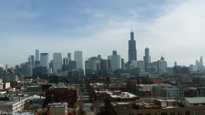 Residential area borders downtown skyscrapers on foggy day