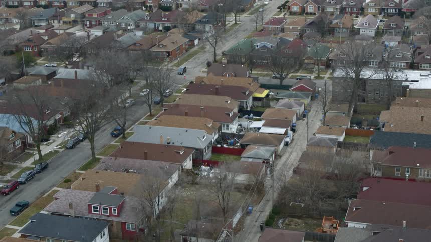 Aerial view of city house with rooftops in the neighborhood