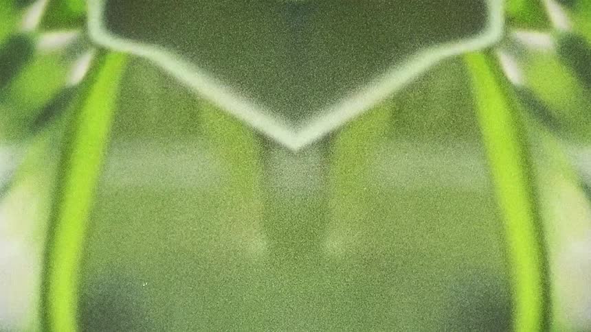Abstract shapes of moving green lines on a mirror reflection caught on vintage film