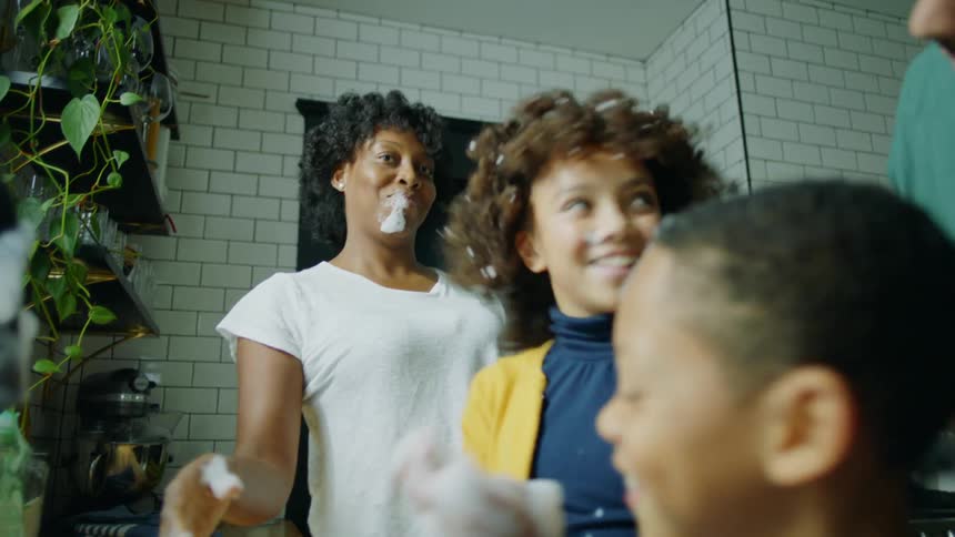 Family plays with soap foams near kitchen sink