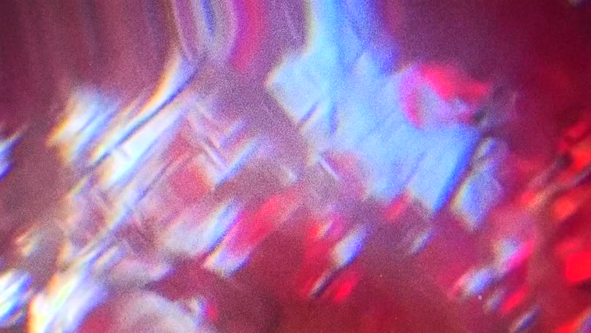 A bright light glows behind purple and pink waves