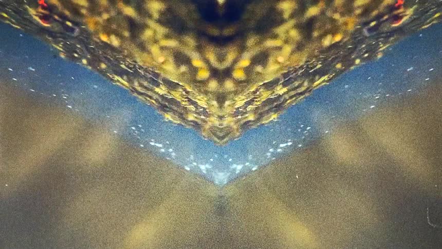 Underwater reflected mirror image of river water flowing caught on vintage film