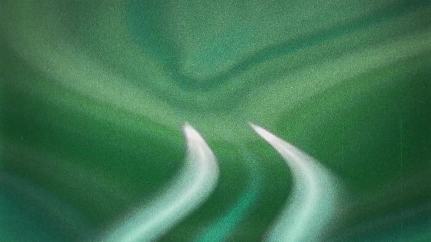 A kaleidoscope of grainy green black and white light blurring and glowing