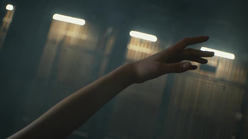 A person is stretching in the dark room