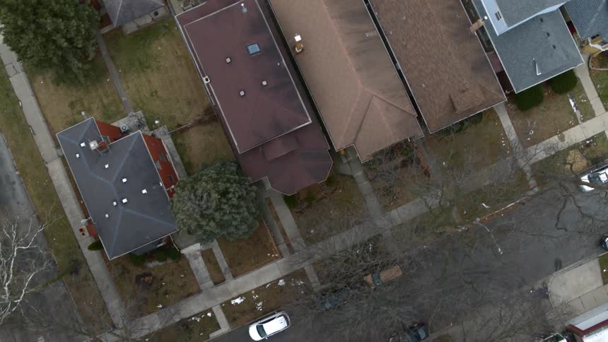 Top down aerial view of the empty streets of a neighborhood in winter