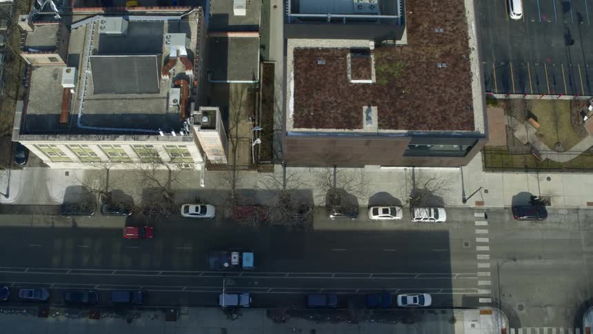 Aerial view of cars driving on a small town neighborhood at morning