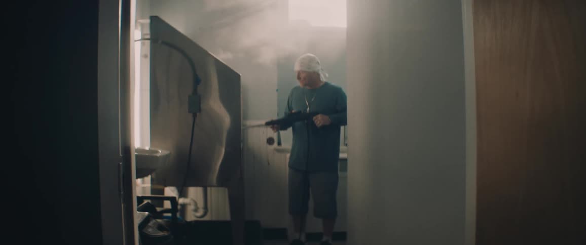 A man is painting a picture on the wall with an airbrush