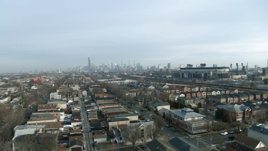 A residential area of a metropolis with skyscrapers looming in the distance