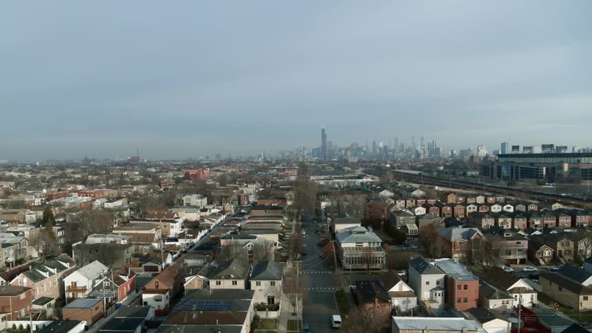 Aerial view of a neighborhood next to the city skyline