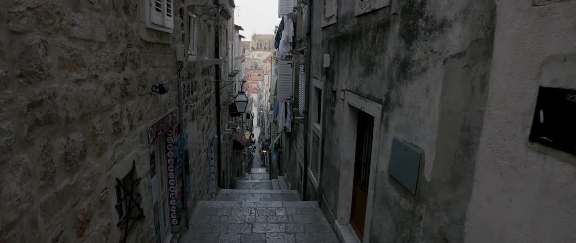City buildings line brick steps in an alley