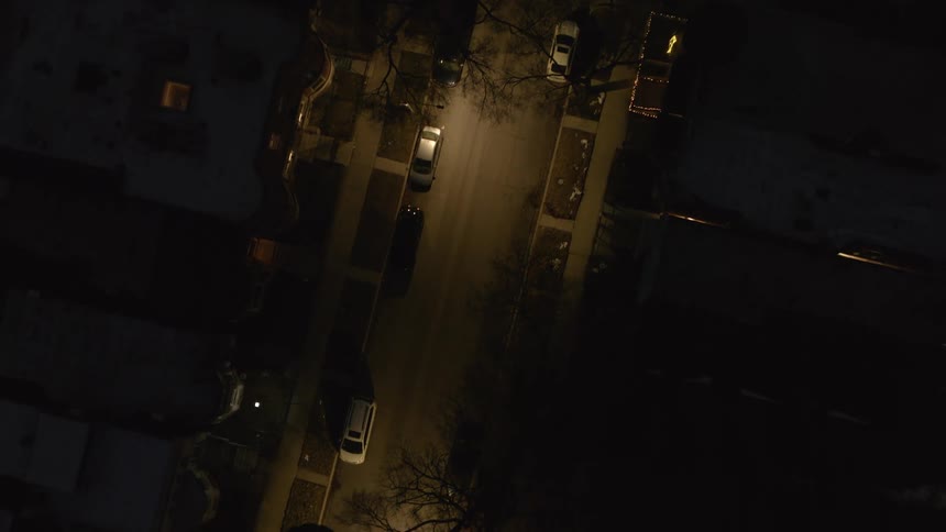 A road through a residential area in a city at night
