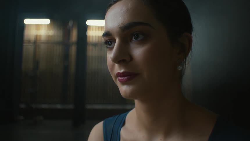 A woman blinks and looks down