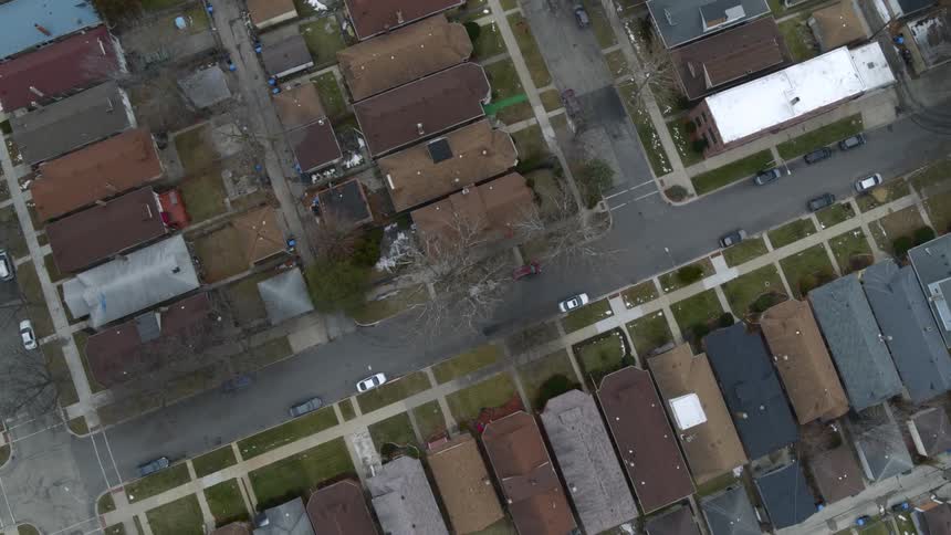 Top down aerial view of houses and empty streets on a neighborhood