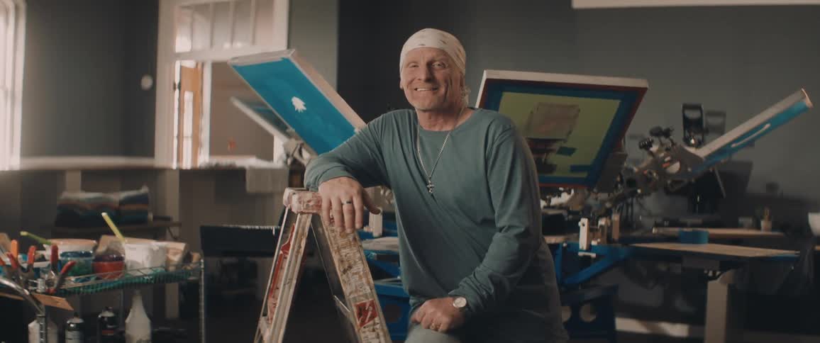 A portrait of a man standing next to a ladder
