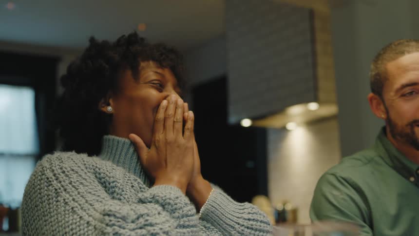 A man and woman smiling in a room