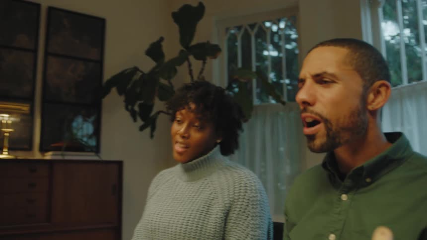 Mother and father sit at dinner table scolding