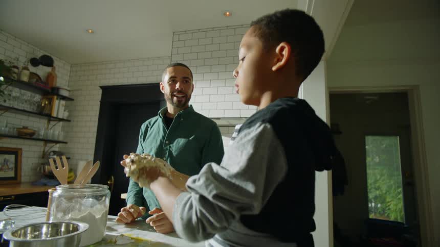 Father scolds as son makes mess of dough as family bakes together