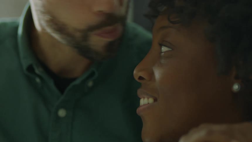 A husband kissing his wife on the head