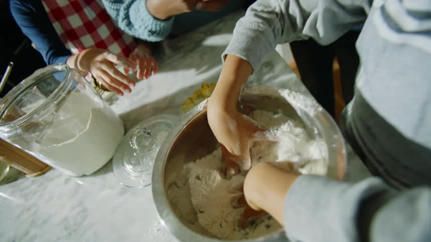A family all baking cookies together