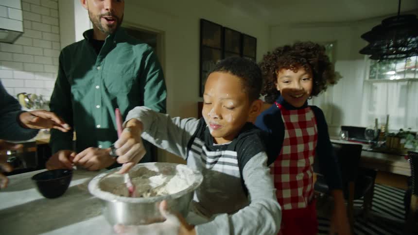 Family have fun cooking together on the kitchen at home
