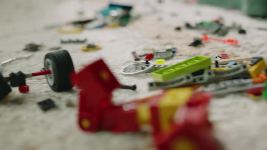A view of legos and toys on the floor of a room