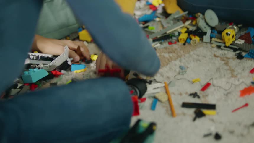 Children play with legos in the bedroom