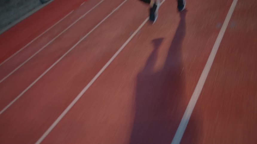 A man is racing on the running track